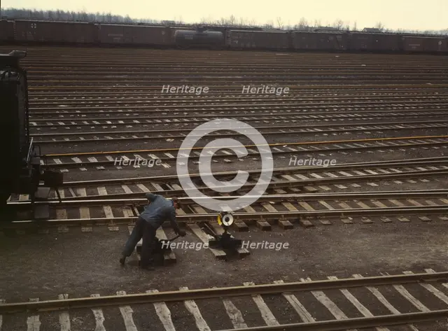 Switchman throwing a switch at C & NW RR's Proviso yard, Chicago, Ill., 1943. Creator: Jack Delano.