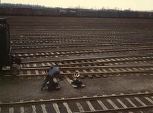 Switchman throwing a switch at C & NW RR's Proviso yard, Chicago, Ill., 1943. Creator: Jack Delano