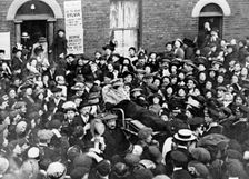 Sylvia Pankhurst leaving the East End of London in a bath-chair, June 1914