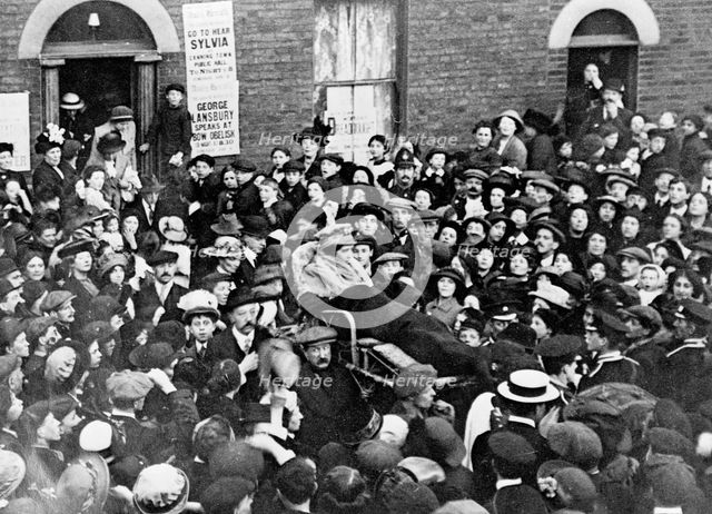Sylvia Pankhurst leaving the East End of London in a bath-chair, June 1914. Artist: Unknown