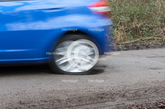 Pot holes in road surface 2017. Creator: Unknown.