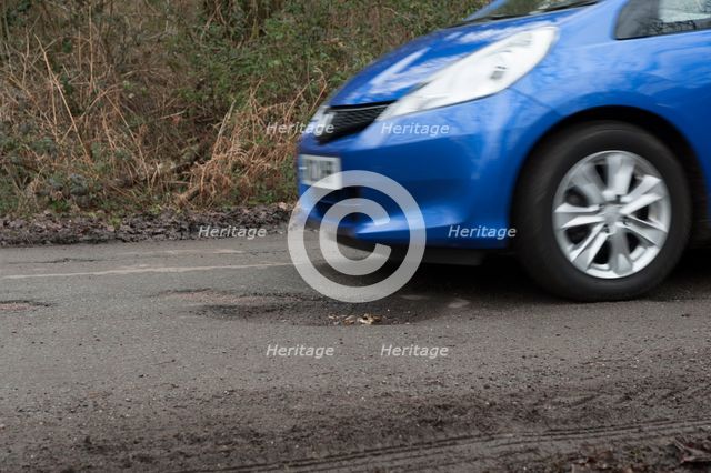 Pot holes in road surface 2017. Creator: Unknown.
