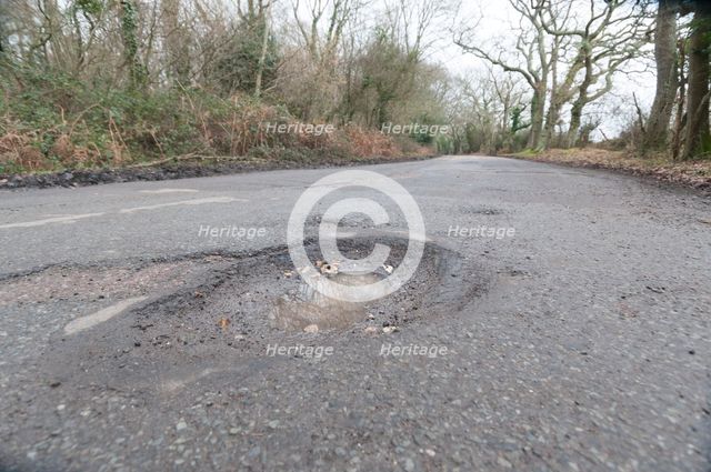 Pot holes in road surface 2017. Creator: Unknown.