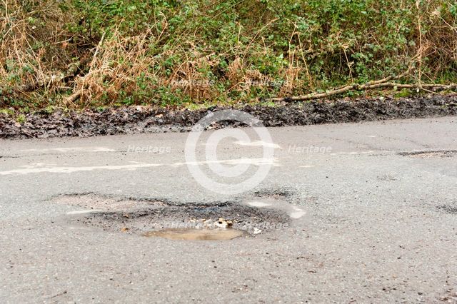 Pot holes in road surface 2017. Creator: Unknown.