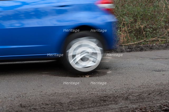 Pot holes in road surface 2017. Creator: Unknown.