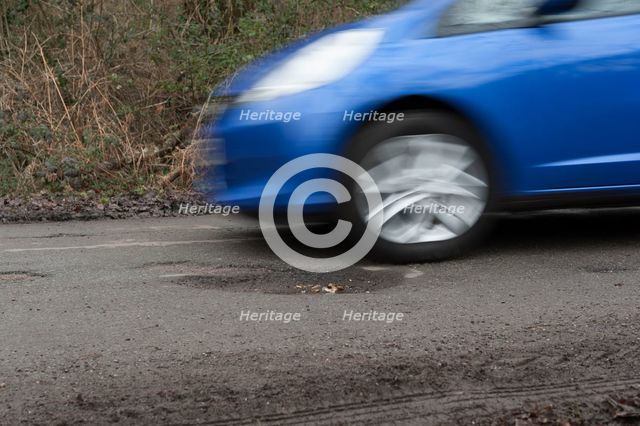 Pot holes in road surface 2017. Creator: Unknown.