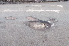 Pot holes in road surface 2017. Creator: Unknown