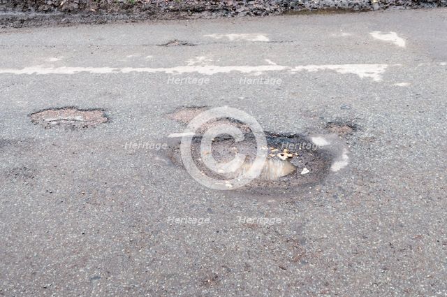 Pot holes in road surface 2017. Creator: Unknown.