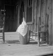 Pottery butter churn on porch of Negro tenant family, Randolph County, North Carolina, 1939. Creator: Dorothea Lange