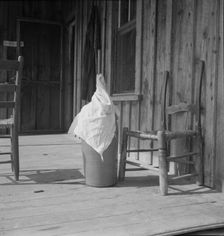 Pottery butter churn on porch of Negro tenant family, Randolph County, North Carolina, 1939. Creator: Dorothea Lange