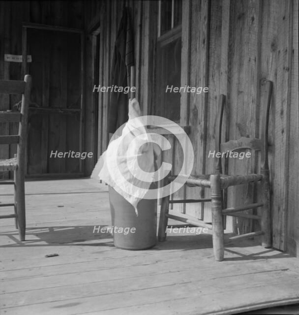 Pottery butter churn on porch of Negro tenant family, Randolph County, North Carolina, 1939. Creator: Dorothea Lange.