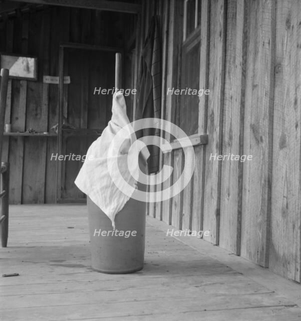 Pottery butter churn on porch of Negro tenant..., Randolph County, North Carolina, 1939. Creator: Dorothea Lange.