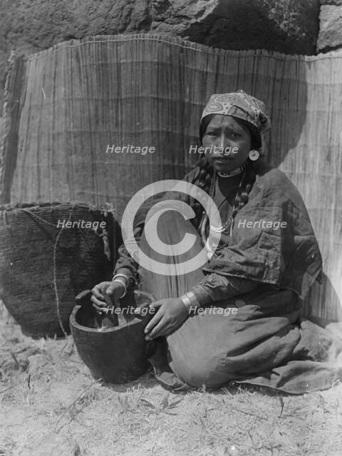 Pounding fish-Wishram, c1910. Creator: Edward Sheriff Curtis.