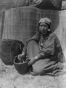 Pounding fish-Wishram, c1910. Creator: Edward Sheriff Curtis