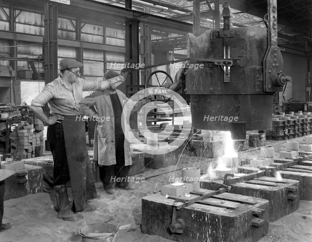 Pouring a small casting at Edgar Allen's Steel foundry, Sheffield, South Yorkshire, 1963. Creator: Michael Walters.
