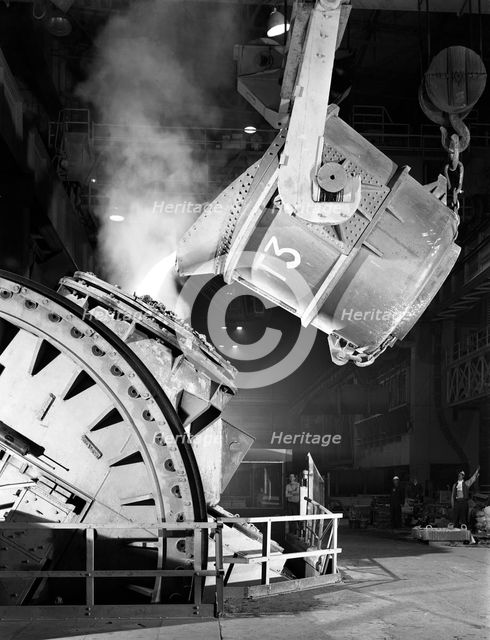 Pouring iron into a Kaldo unit, Park Gate Iron and Steel Co, Rotherham, South Yorkshire, 1964. Creator: Michael Walters.