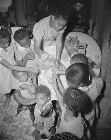 Pouring lemonade at a birthday party on Seaton Road, Washington, D.C., 1942. Creator: Gordon Parks