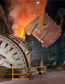 Pouring molten iron into a Kaldo unit, Park Gate Iron & Steel Co, Rotherham, South Yorkshire, 1964. Creator: Michael Walters
