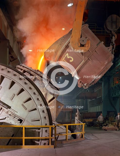 Pouring molten iron into a Kaldo unit, Park Gate Iron & Steel Co, Rotherham, South Yorkshire, 1964. Creator: Michael Walters.