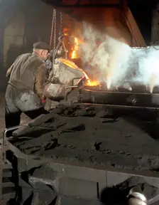 Pouring molten metal from a cupola into moulds, steel bath production, Hull, Humberside, 1965. Creator: Michael Walters