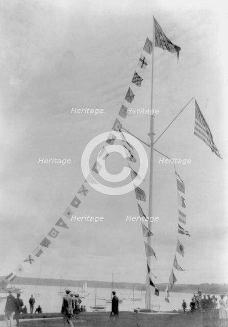 Pole with flags of different countries; sailboats in background, Oyster Bay, Long Island, N.Y., 1905 Creator: Frances Benjamin Johnston.