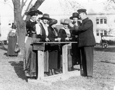Police officer teaching women how to shoot, c. 1920