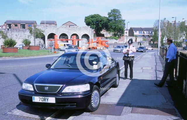 Policeman checking driver documents. Artist: Unknown.