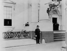 Policeman standing guard at entrance to White House, between 1889 and 1906. Creator: Frances Benjamin Johnston