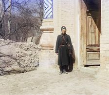 Policeman standing in front of doorway, between 1905 and 1915. Creator: Sergey Mikhaylovich Prokudin-Gorsky
