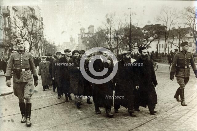 Polish Jews being escorted by German soldiers and Gestapo, Poland, March 1940. Artist: Unknown