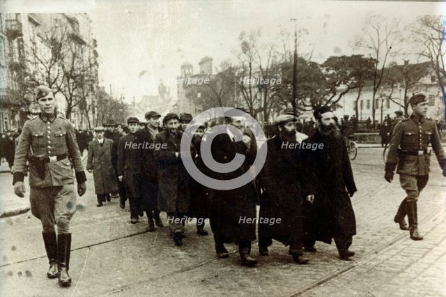 Polish Jews being escorted by German soldiers and Gestapo, Poland, March 1940. Creator: Unknown.