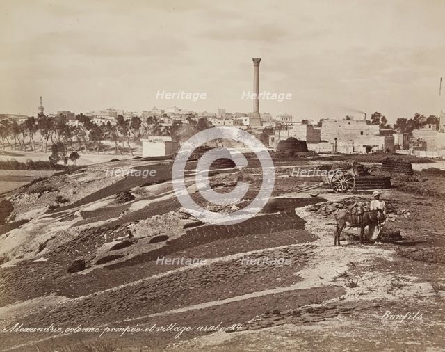 Pompey's Pillar and Arab Village at Alexandria, 19th century. Creator: Maison Bonfils.