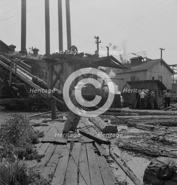 Pond monkey guides..., Pelican Bay Lumber Company mill, Klamath Falls, Oregon, 1939. Creator: Dorothea Lange.