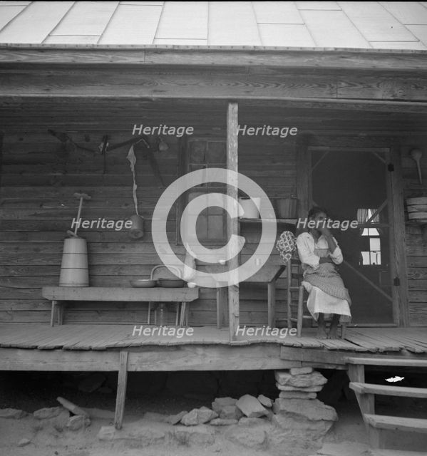 Porch of Negro tenant house, showing household equipment, Person County, North Carolina, 1939. Creator: Dorothea Lange.