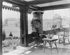 Porch with wicker furniture, and view over lawn to home of Edmund..., Greenwich, Connecticut, 1908. Creator: Frances Benjamin Johnston