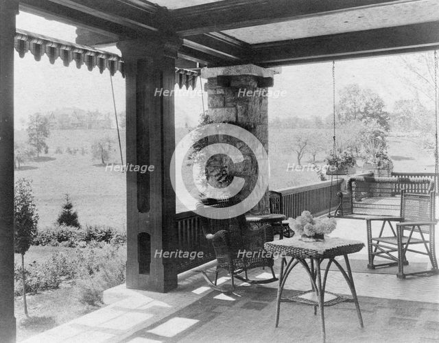 Porch with wicker furniture, and view over lawn to home of Edmund..., Greenwich, Connecticut, 1908. Creator: Frances Benjamin Johnston.