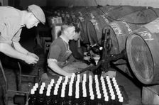 Port wine being bottled from the barrel at the Cutler Street warehouses, London, c1945-c1965. Artist: SW Rawlings