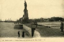 Port Said. - Lesseps Statue and entrance to the Suez Canal - LL. c1918-c1939. Creator: Unknown