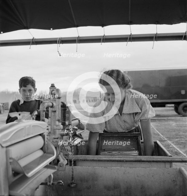 Portable laundry unit, shower unit beyond, FSA camp, Merrill, Oregon, 1939. Creator: Dorothea Lange.