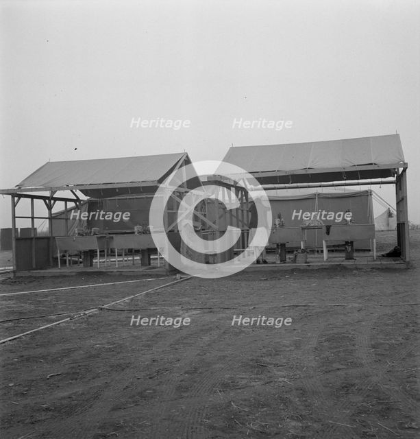 Portable laundry unit, shower unit beyond, FSA camp, Merrill, Oregon, 1939. Creator: Dorothea Lange.