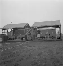 Portable laundry unit, shower unit beyond, FSA camp, Merrill, Oregon, 1939. Creator: Dorothea Lange