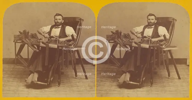 Portrait of Charles H. Barnes, Hardwick, Mass. seated in handicapped-style chair making ..., 1870s. Creator: George T Putnam.