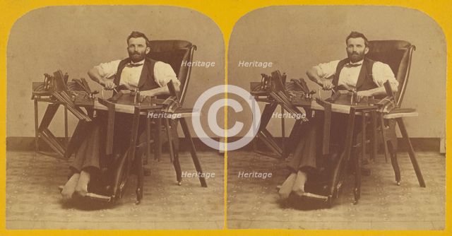 Portrait of Charles H. Barnes, Hardwick, Mass. seated in handicapped-style chair making ..., 1870s. Creator: George T Putnam.