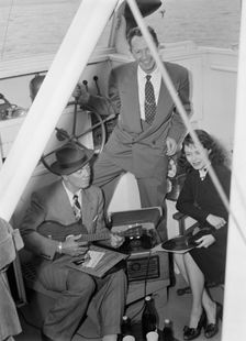 Portrait of Cliff Edwards, Betty Brewer, and Frank...Ukelele Lady (yacht), Hudson River, N.Y., 1947. Creator: William Paul Gottlieb