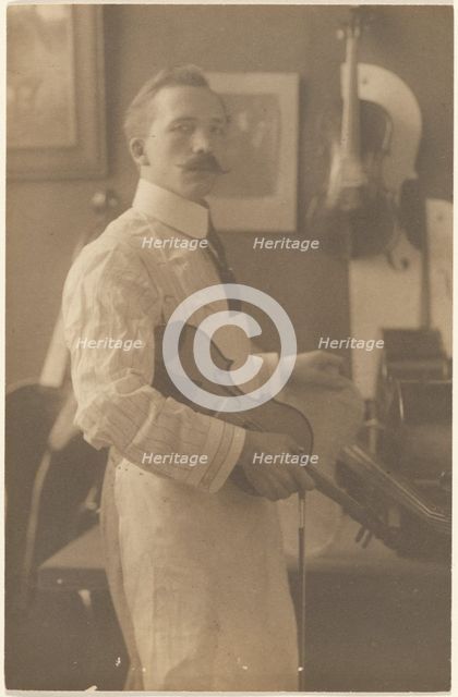 Portrait of a Violin Maker in Studio, 1895-1943. Creator: Louis Fleckenstein.
