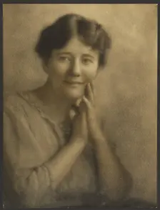 Portrait of a Woman with Hands Clasped at Face, 1907-1924. Creator: Louis Fleckenstein
