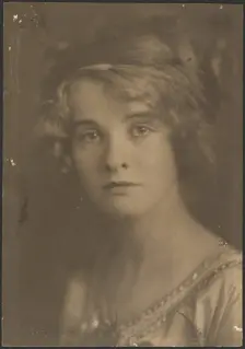 Portrait of a Woman Holding Bouquet with Fern, 1907-1924. Creator: Louis Fleckenstein