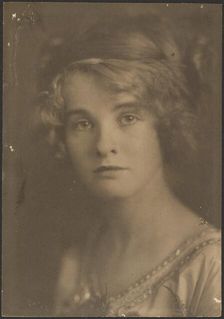 Portrait of a Woman Holding Bouquet with Fern, 1907-1924. Creator: Louis Fleckenstein
