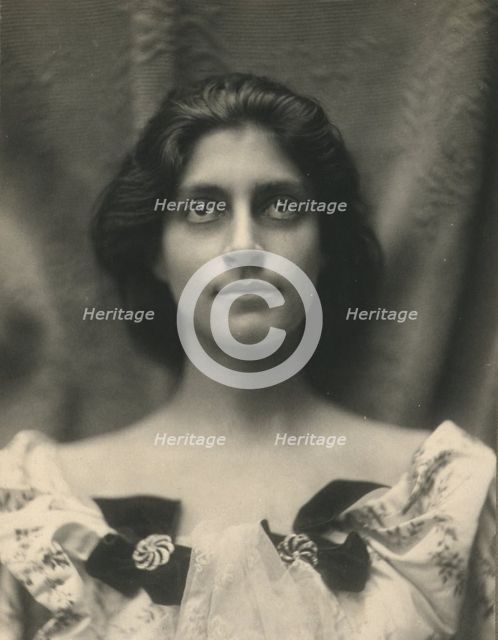 Portrait of a woman in a floral dress adorned with diamond brooches and bows, c1900. Creator: Virginia M Prall.