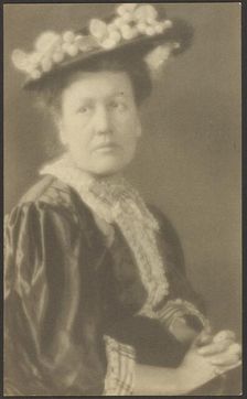 Portrait of a Woman in Hat with Dogwood Flowers, 1907-1943. Creator: Louis Fleckenstein